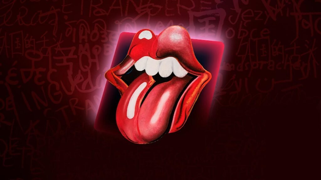 A imagem destaca uma colaboração especial entre a Roblox e a lendária banda The Rolling Stones, apresentando o icônico logotipo da boca com a língua para promover o evento musical disponível na plataforma. Com um fundo em tons de vermelho e elementos gráficos inspirados no universo da banda, a arte representa a experiência interativa em que os jogadores podem explorar conteúdos exclusivos, participar de atividades temáticas e acompanhar uma apresentação virtual com grandes sucessos dos Rolling Stones dentro do universo da Roblox